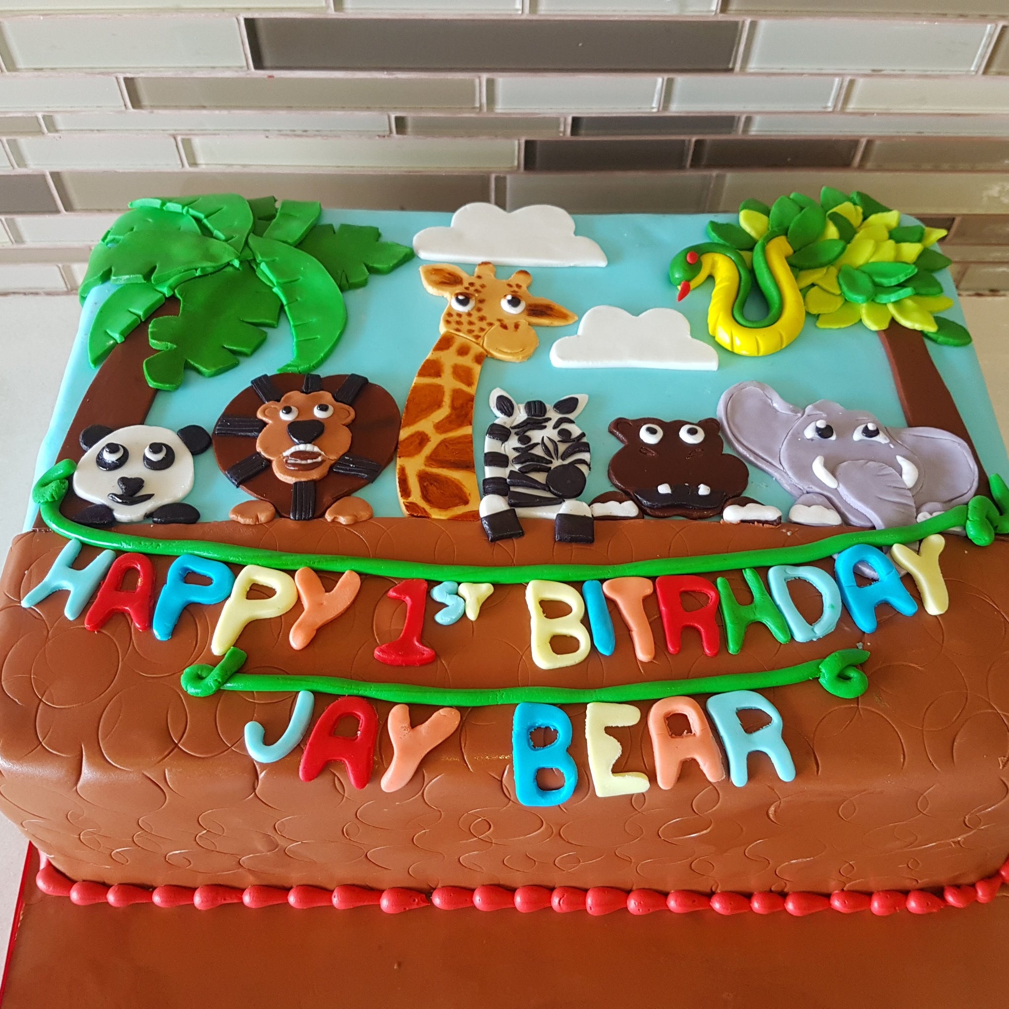 Animal theme 1st birthday fondant cake