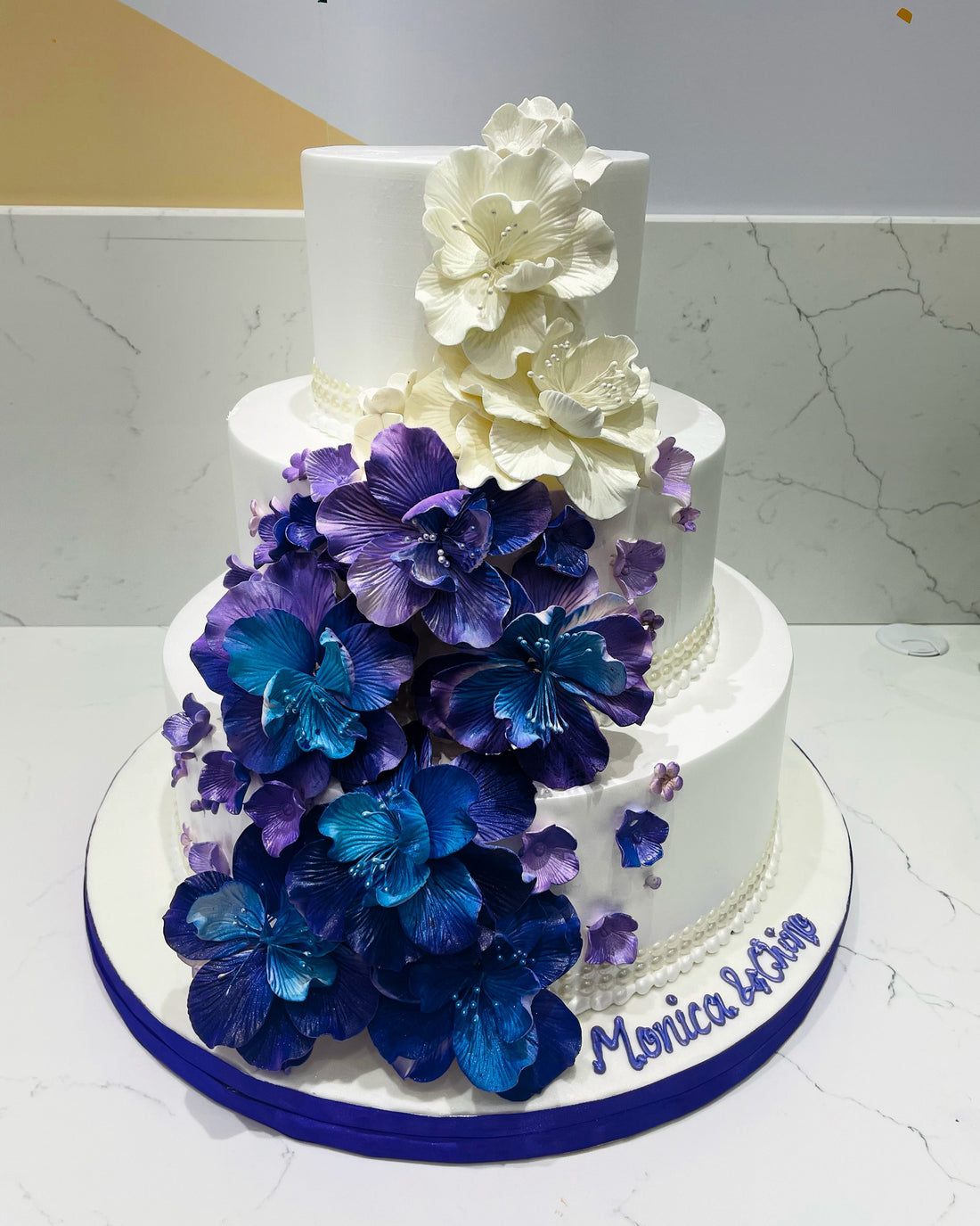 PURPLE & BLUE CASCADING FLOWERS WEDDING CAKE