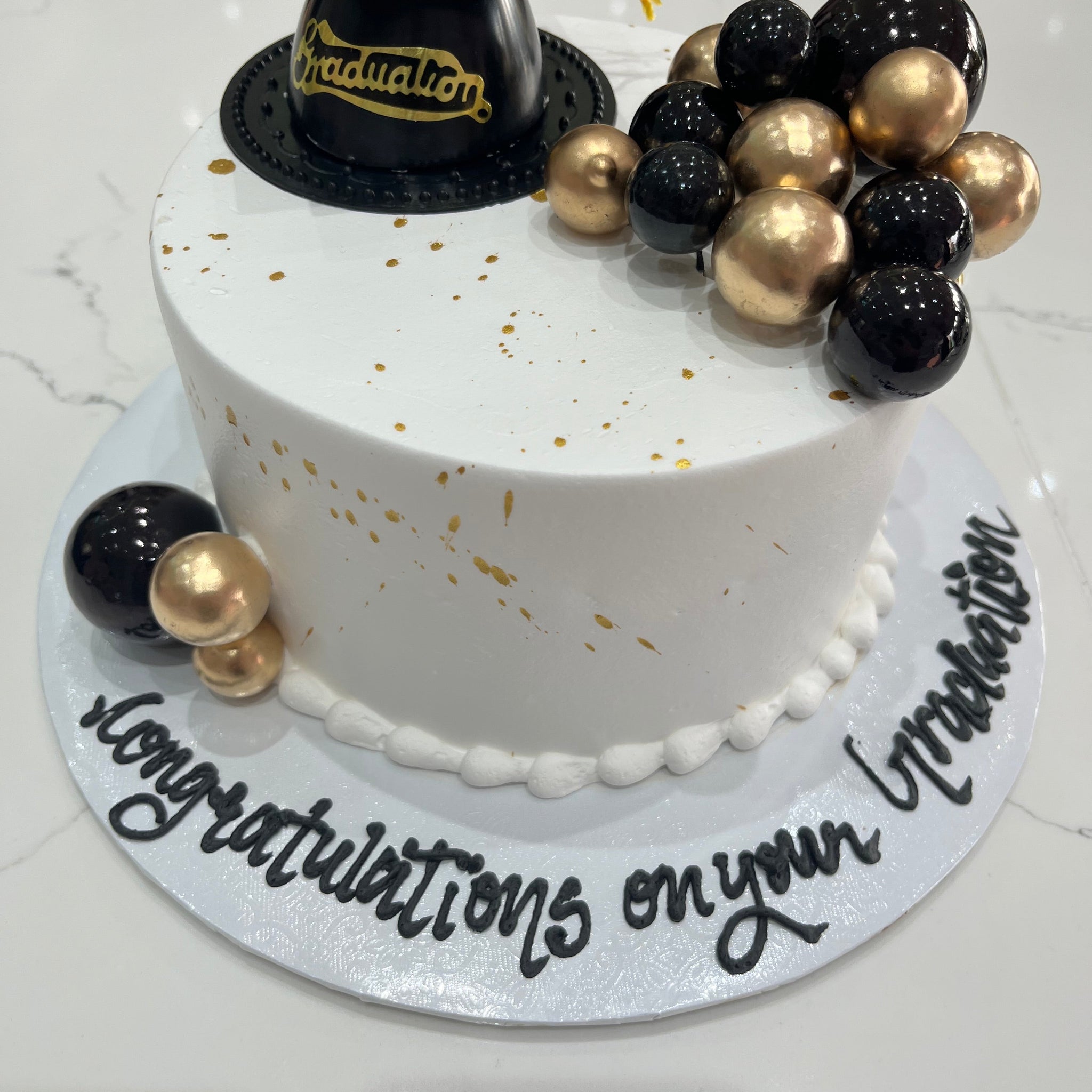 BLACK & GOLD GRADUATION CREAM CAKE