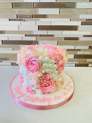 PINK AND IVORY CREAM ROSETTE CAKE