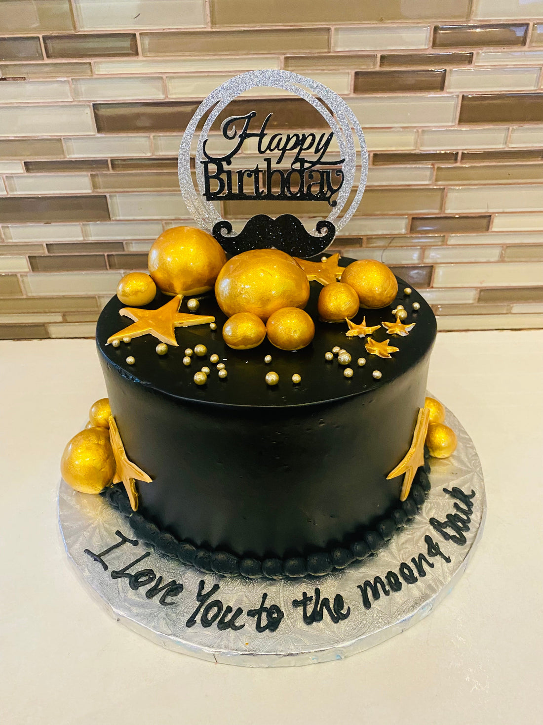 BLACK AND GOLD MOUSTACHE CAKE