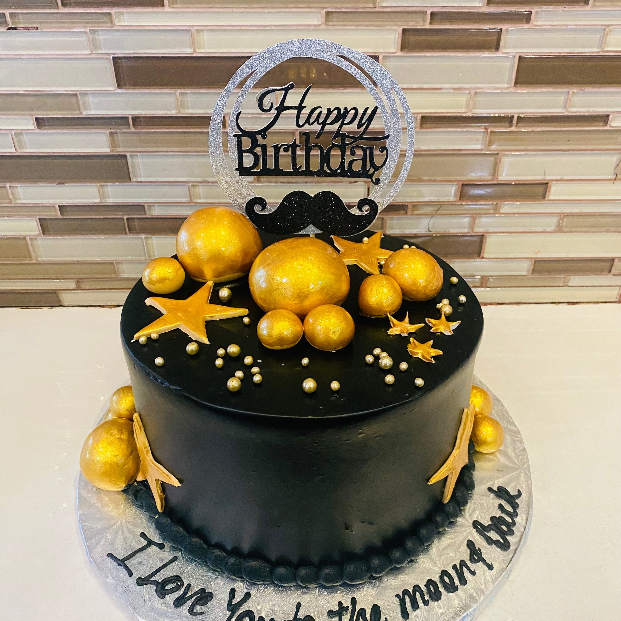 BLACK AND GOLD MOUSTACHE CAKE