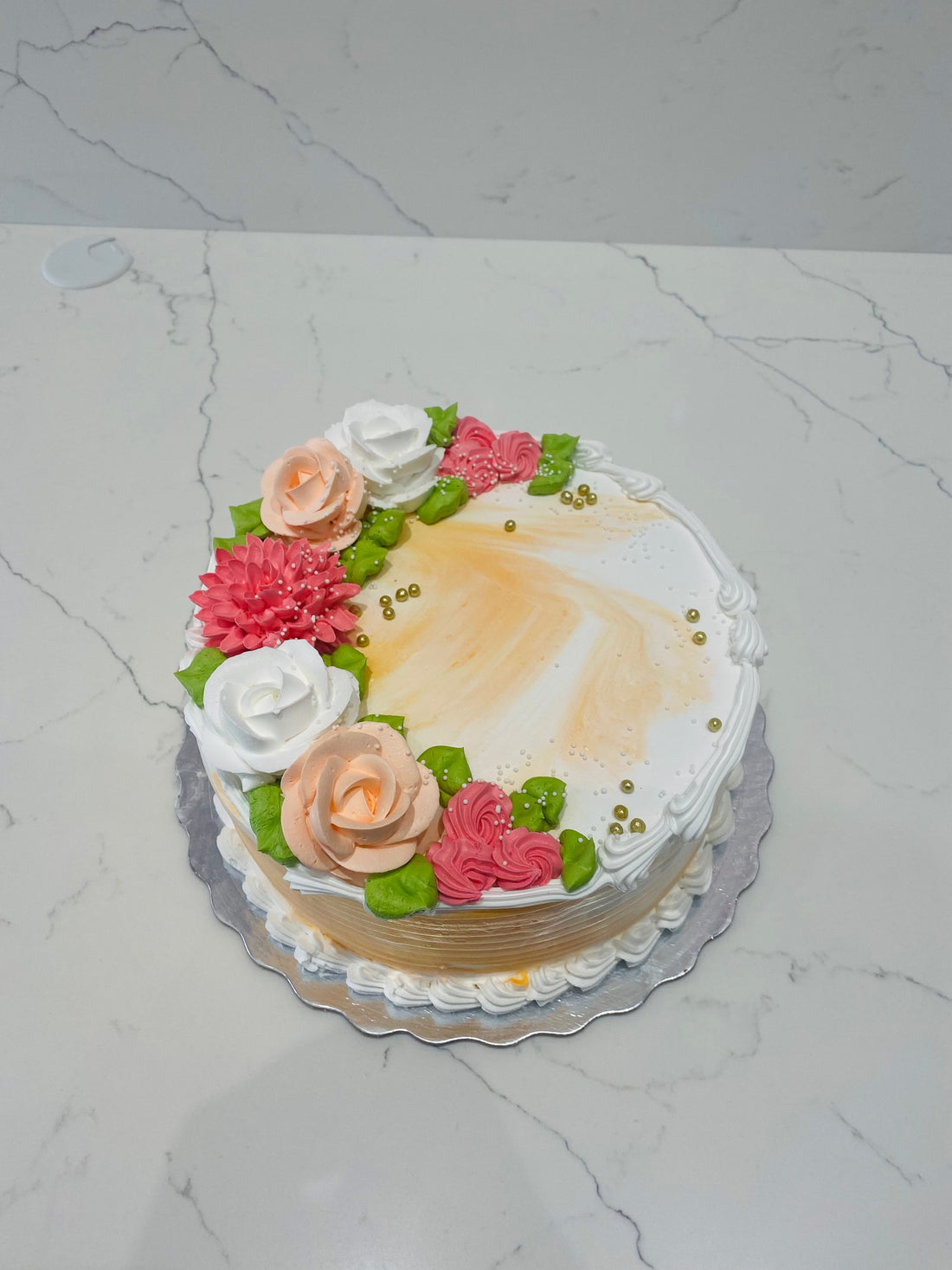 ORANGE AND WHITE CREAM FLOWER CAKE